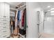 Walk-in closet featuring custom shelving, drawers, and rods to maximize storage space at 600 Sutton Pl # 101B, Longboat Key, FL 34228
