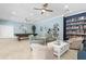Clubhouse great room with tile floors, pool table, sitting area, book shelves and ceiling fans at 600 Sutton Pl # 101B, Longboat Key, FL 34228