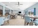 Spacious community room with plenty of tables, chairs, and natural light for residents to enjoy at 600 Sutton Pl # 101B, Longboat Key, FL 34228