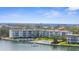 Beautiful waterfront condo with a pool and boat dock, offering stunning ocean views on a clear, sunny day at 600 Sutton Pl # 101B, Longboat Key, FL 34228