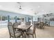 A community game room features tables, chairs, ceiling fans, and a refreshment area with a sink at 600 Sutton Pl # 101B, Longboat Key, FL 34228