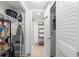Hallway view of storage with shelving, and the walk-in shower bathroom at 600 Sutton Pl # 101B, Longboat Key, FL 34228