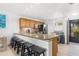 Bright kitchen features a peninsula island with granite countertops and bar stool seating at 600 Sutton Pl # 101B, Longboat Key, FL 34228