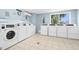 Clean and well-maintained community laundry room with multiple washers and dryers for residents at 600 Sutton Pl # 101B, Longboat Key, FL 34228