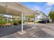 Assigned covered parking spot in front of unit with mature landscaping in a well maintained condominium complex at 600 Sutton Pl # 101B, Longboat Key, FL 34228