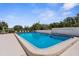 A refreshing pool is surrounded by lounge chairs and trees making it the perfect spot to relax and unwind at 600 Sutton Pl # 101B, Longboat Key, FL 34228