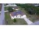 Aerial view of home with solar panels, a driveway, landscaping, and a lush green lawn at 7882 Dulce Ave, North Port, FL 34287