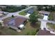 Aerial view of a home with solar panels, a screened lanai, and well-maintained landscaping at 7882 Dulce Ave, North Port, FL 34287