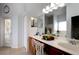 Well-lit bathroom with double sinks, large mirror, and stylish decor at 7882 Dulce Ave, North Port, FL 34287