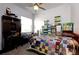 Bedroom with a ceiling fan and colorful quilt at 7882 Dulce Ave, North Port, FL 34287