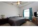 Bright bedroom with ceiling fan, dresser with television, and natural light at 7882 Dulce Ave, North Port, FL 34287