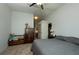 Comfortable bedroom featuring a ceiling fan, wooden dresser and a wardrobe at 7882 Dulce Ave, North Port, FL 34287