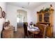 Charming dining area with wooden table and chairs, complemented by a classic hutch at 7882 Dulce Ave, North Port, FL 34287