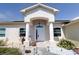 Inviting front entrance with pillars, arched doorway and manicured landscaping at 7882 Dulce Ave, North Port, FL 34287