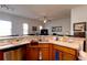 Kitchen with stainless steel dishwasher and sink, with a view into the living room at 7882 Dulce Ave, North Port, FL 34287