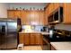 Kitchen featuring stainless steel appliances and ample wood cabinetry at 7882 Dulce Ave, North Port, FL 34287
