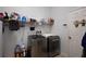 Modern laundry room equipped with stainless steel washer and dryer, complemented by ample shelving at 7882 Dulce Ave, North Port, FL 34287