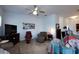 Spacious living room with neutral carpet, ceiling fan, and ample seating at 7882 Dulce Ave, North Port, FL 34287
