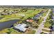 Waterfront community aerial view showcasing pool homes and a nearby golf course for recreation at 82 Caddy Rd, Rotonda West, FL 33947