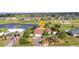 Aerial view shows manicured lawn and landscaping near golf course and waterways at 82 Caddy Rd, Rotonda West, FL 33947