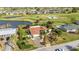 A home nestled in a golf community, enhanced by lush landscaping and a peaceful pond at 82 Caddy Rd, Rotonda West, FL 33947
