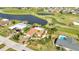 Light blue single-story home near a golf course and pond, complete with a private pool at 82 Caddy Rd, Rotonda West, FL 33947