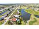 Beautiful aerial view of a neighborhood on canals and a golf course with lush green fairways and manicured lawns at 82 Caddy Rd, Rotonda West, FL 33947