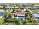 Charming aerial view of a home featuring a pool, tropical landscaping, and easy canal access at 82 Caddy Rd, Rotonda West, FL 33947