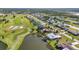Sprawling community aerial featuring waterfront properties, golf course, and neighborhood streets at 82 Caddy Rd, Rotonda West, FL 33947