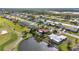 Amazing aerial view showcases a home with a pool, tropical landscaping, and canal access at 82 Caddy Rd, Rotonda West, FL 33947