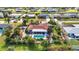 Attractive aerial view of a home featuring a pool, tropical landscaping and canal views at 82 Caddy Rd, Rotonda West, FL 33947