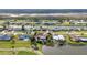 Attractive aerial view of waterfront homes with lush landscaping and tranquil canals at 82 Caddy Rd, Rotonda West, FL 33947