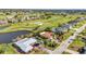 Lovely aerial scene shows golf course homes with water views, lush greenery, and nearby ponds at 82 Caddy Rd, Rotonda West, FL 33947