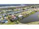 Stunning aerial view of waterfront homes along canals, boasting lush landscaping and serene water views at 82 Caddy Rd, Rotonda West, FL 33947