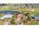 Charming light blue single-Gathering home adjacent to a pond and golf course with a well-manicured lawn at 82 Caddy Rd, Rotonda West, FL 33947