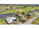 A delightful aerial shot of homes bordering the golf course, with ponds, and inviting community at 82 Caddy Rd, Rotonda West, FL 33947