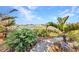 Landscaped backyard with gravel path leading to a lake view at 82 Caddy Rd, Rotonda West, FL 33947