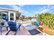 Charming backyard patio with cozy seating, vibrant landscaping, and a serene pool view for relaxing outdoor living at 82 Caddy Rd, Rotonda West, FL 33947
