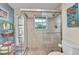 Beautiful bathroom featuring tiled shower, vanity and stained glass at 82 Caddy Rd, Rotonda West, FL 33947
