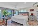 Bedroom with a large bed, window views, neutral decor, and a cozy atmosphere at 82 Caddy Rd, Rotonda West, FL 33947
