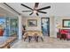 Dining area features tile flooring, ceiling fan, table with seating, and door to outdoor patio at 82 Caddy Rd, Rotonda West, FL 33947