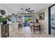 Bright dining area features tile flooring, ceiling fan, table with seating, and sliding doors to outdoor patio at 82 Caddy Rd, Rotonda West, FL 33947