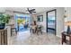 Cozy dining area featuring tiled floors, a dining table, and a doorway leading to the sunroom and bedroom at 82 Caddy Rd, Rotonda West, FL 33947