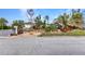 Landscaped front yard with lush tropical plants and rock features creates beautiful curb appeal at 82 Caddy Rd, Rotonda West, FL 33947