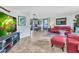 Spacious living room featuring tile flooring, comfortable seating, and an open layout leading to the dining area at 82 Caddy Rd, Rotonda West, FL 33947