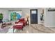 Bright living area featuring tile floors, eclectic furniture, and a large window offering natural light at 82 Caddy Rd, Rotonda West, FL 33947