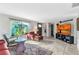 Bright and airy living room featuring tile floors, comfortable seating, and a large television for entertainment at 82 Caddy Rd, Rotonda West, FL 33947