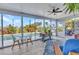 Screened-in patio with tile flooring and view of the outdoor pool area at 82 Caddy Rd, Rotonda West, FL 33947