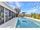 Inviting pool area with water views, lush landscaping, and comfortable seating, perfect for outdoor relaxation and entertaining at 82 Caddy Rd, Rotonda West, FL 33947