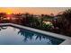 Beautiful pool reflecting sunset and tropical plants at 82 Caddy Rd, Rotonda West, FL 33947